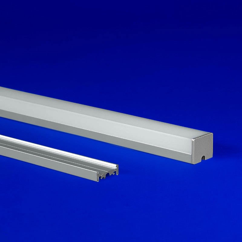 LED aluminum extrusion with a distinct three-sided lens, ideal for grid ceiling and surface mount setups, seamlessly blending with its luminous design
